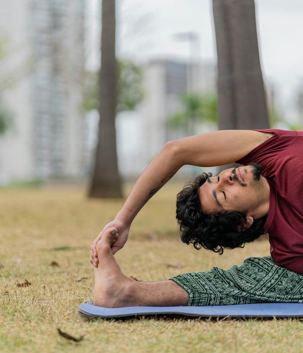 Man stretching outdoors with a serene natural background.